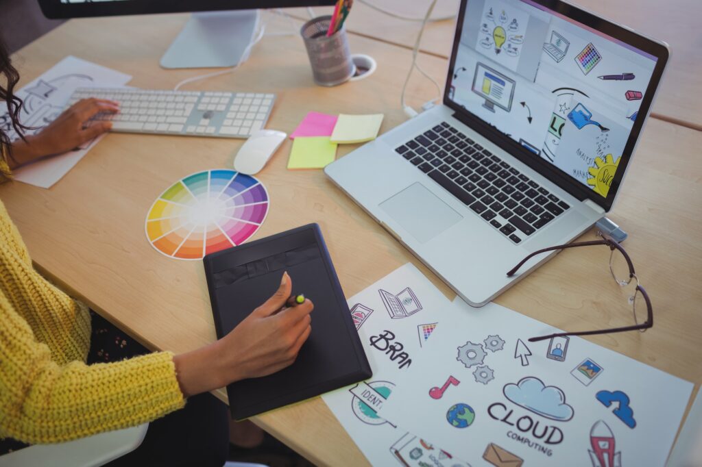 Female editor using digitizer on desk in office