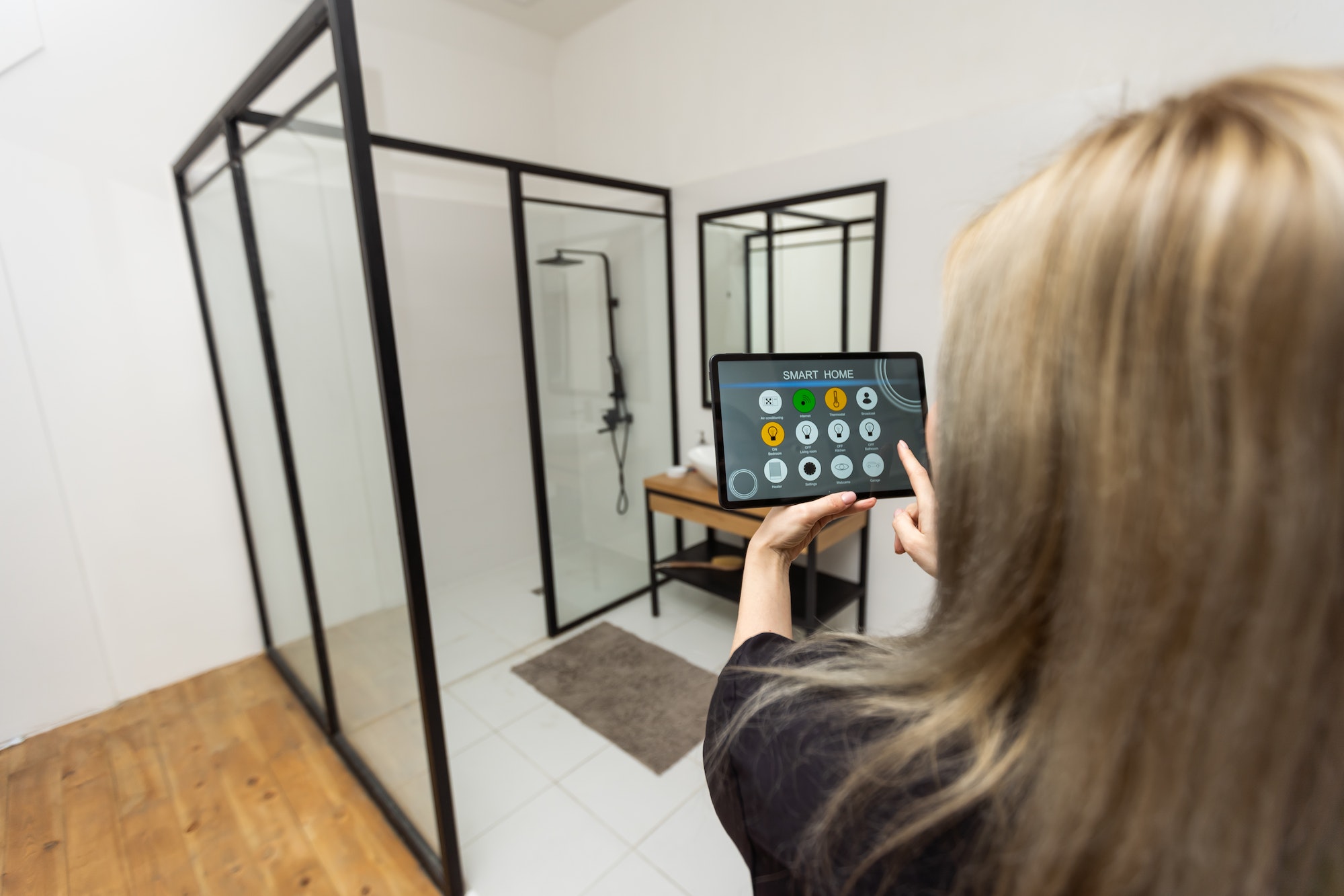 Woman at home using smart screen, automation domestic system